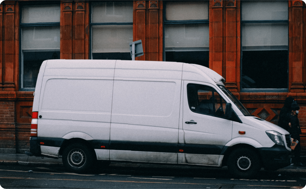 A white van parked outside a building